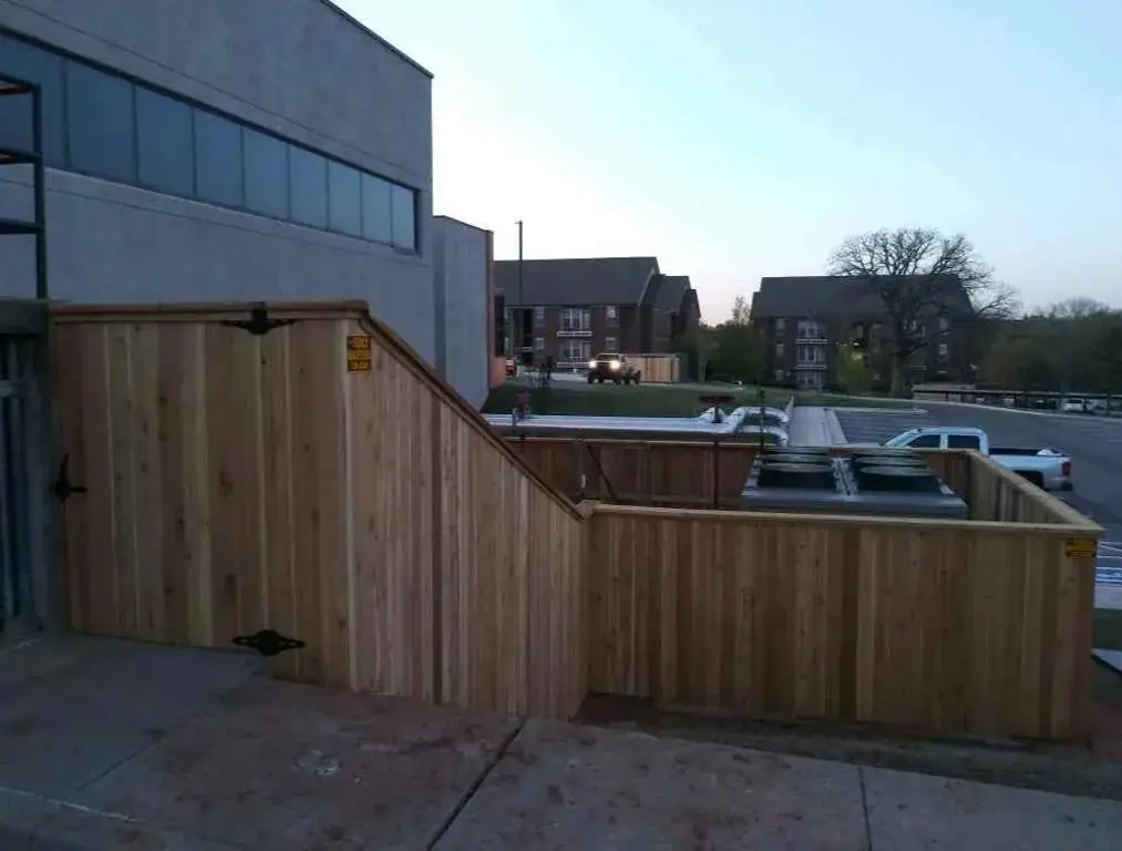 Commercial cedar rooftop-equipment enclosure fence built by Fence Masters on an Oklahoma City jobsite